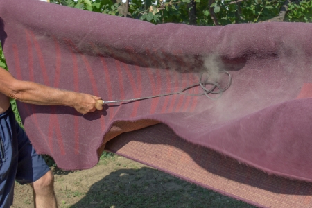 a rug beater is a device for hand-beating dust and dirt out of a rug